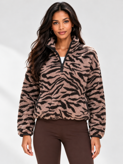 Female model wearing tiger print half zip fleece sweatshirt street casual look